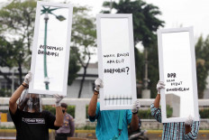 Activists from the #BersihkanIndonesia movement stage a protest against the deliberation of the omnibus bill on job creation in front of the House of Representatives complex in Jakarta on July 9. JP/Wendra Ajistyatama