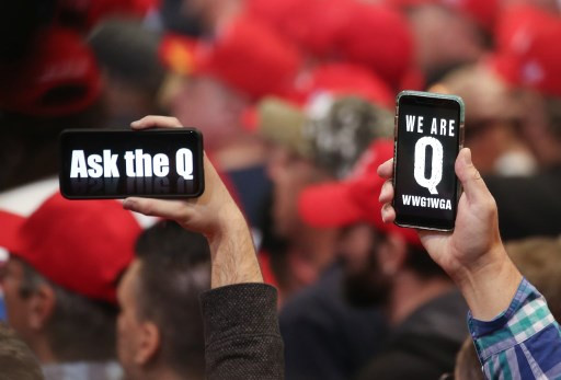 Supporters of President Donald Trump hold up their phones with messages referring to the QAnon conspiracy theory at a campaign rally at Las Vegas Convention Center on Feb. 21, 2020 in Las Vegas, Nevada.