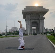 Swedish Ambassador Joachim Bergstrom practices yoga near the Arch of Triumph in Pyongyang, North Korea, July 13, 2020. 