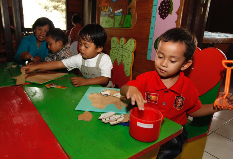 Learning by playing: Children play at an early childhood education (PAUD) center near Danone's factory in Prambanan near Yogyakarta. The center was built and supported by Danone Specialized Nutrition Indonesia. The photo was taken before the COVID-19 pandemic.
