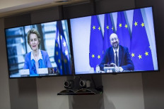 European Council President Charles Michel (right) and European Commission President Ursula von der Leyen are sen on screen as they hold a videoconference  prior to EU-UK talks via videoconference, at the European Council building in Brussels on June 15, 2020. - EU chiefs held a videoconference with the British prime minister on June 15 to breathe new life into stalled post-Brexit trade talks, with both sides entrenched in long-held positions. Expectations are low for the long-planned meeting, with all sides agreeing last week that trade negotiations would be intensified over the coming months.