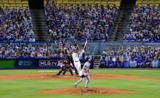 Enrique Hernandez #14 of the Los Angeles Dodgers hits a two run homerun off of Conner Menez #51 of the San Francisco Giants, to take an 8-1 lead during the eighth inning, on MLB Opening Day at Dodger Stadium on July 23, 2020 in Los Angeles, California. The 2020 season had been postponed since March due to the COVID-19 Pandemic. 