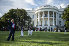 US President Donald Trump plays catch with Mariano Rivera (off frame), the MLB Hall of Fame closer from the Yankees, during a Major League Baseball Opening Day event at the White House in Washington, DC, on July 23, 2020. 
