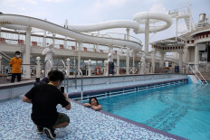 An internet show host poses in the swimming pool on the Explorer Dream cruise ship in Keelung, Taiwan, July 26, 2020. 