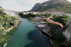 A man jumps from the Old Bridge during the 454th traditional diving competition in Mostar, Bosnia and Herzegovina, July 26, 2020. 