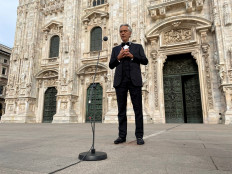 Italian opera singer Andrea Bocelli rehearses in an empty Duomo square on Easter Sunday ahead of a livestreamed concert for the event ''Music for hope'', inside the empty Duomo cathedral, which is intended as a symbol of love, hope and healing amidst the coronavirus disease (COVID-19) outbreak, in Milan, Italy, on April 12, 2020. 