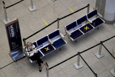 A passenger wears a face mask at the Check-in area of the Santos Dumont airport in Rio de Janeiro, Brazil, on May 27, 2020. 