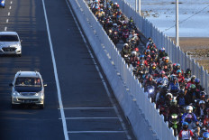 Motorists pass over the Suramadu Bridge in Bangkalan, East Java, on July 30, 2020. The bridge, which connects the islands of Java and Madura, was crowded with homebound travelers for the Idul Adha holiday.