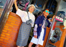 In this undated handout photo released by Reef Chang on August 1, 2020 Chang Wan-ji (R) and his wife Hsu Sho-er pose for photographs at their laundry store in Taichung. 