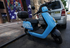 In this file photo a Revel ridesharing moped is seen parked in midtown New York City on July 28, 2020, after the company announced it is suspending its service in New York City following the death of a second rider in Queens. 