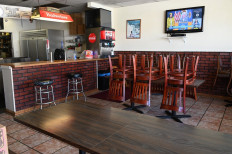 Los Angeles County Public Health Director Barbara Ferrer speaks during a news conference July 22, 2020 seen on a television in an empty pizza restaurant open only for take away, in Glendale, California. 