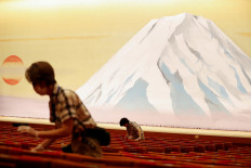 Workers wearing protective face masks disinfect seats at the Kabukiza Theatre, where Japan's stately traditional Kabuki theater will resume on August 1 following a five-month closure due to the coronavirus disease (COVID-19) outbreak, in Tokyo, Japan, on July 31, 2020. 