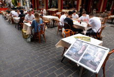 A sign is pictured outside a restaurant on the opening day of 'Eat Out to Help Out' scheme amid the coronavirus disease (COVID-19) outbreak, in Chinatown, London, Britain, August 3, 2020.  