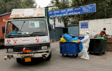 A medical staff member wearing personal protective equipment (PPE) pushes a trolley containing medical waste bags to a Bio-Medical Waste storage area, during the coronavirus disease (COVID-19) outbreak, in New Delhi, India, July 17, 2020. Reuters/Adnan Abidi 