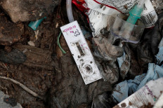 A COVID-19 testing kit lies on the floor at a landfill site, during the coronavirus disease (COVID-19) outbreak, in New Delhi, India, July 22, 2020. Reuters/Adnan Abidi 