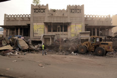 Caterpillars are seen in action at the start of the demolition work of the Sandaga market in Dakar, on August 2, 2020.
