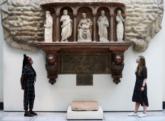 Victoria & Albert (V&A) Museum gallery assistants pose for members of the media in front of the 'Monument of Marchese Spinetta Malaspina' during preparations to reopen the museum, in London, after the outbreak of the coronavirus disease (COVID-19) caused its closure, in London, Britain, August 4, 2020. 