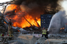 Firefighters douse a blaze at the scene of an explosion at the port of Lebanon's capital Beirut on August 4, 2020. - Two huge explosion rocked the Lebanese capital Beirut, wounding dozens of people, shaking buildings and sending huge plumes of smoke billowing into the sky. Lebanese media carried images of people trapped under rubble, some bloodied, after the massive explosions, the cause of which was not immediately known. AFP/Str