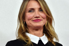 US actress Cameron Diaz poses for pictures during a photocall for the film 'Annie' in central London on December 16, 2014. 