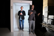 Portl inventor David Nussbaum poses for a photo next to an A.I.-powered life-size hologram of himself in Gardena, near Los Angeles, California, United States, on August 3, 2020. 