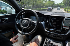 This photo taken on July 22, 2020 shows a driver sitting in a Didi Chuxing autonomous taxi during a pilot test drive on the streets in Shanghai. 