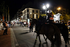 Dutch and Belgian police officers on horseback patrol on the streets around closing time, in the nightlife neighborhood of Knokke, on July 11, 2020 after recent trouble by partying youth after the mandatory closing time of bars and restaurants following strict regulations to curb the spread of the novel coronavirus crisis, COVID-19. 