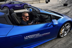 This photo taken on June 13, 2020 shows Thai business owner Thanakorn Mahanontharit, also known as Yod, getting into a Lamborghini car during a testing session for clients in Bangkok. - With tourism and exports in freefall, Thailand's growth could shrivel by as much as 10 percent this year, dumping millions into unemployment. But in a split-screen economy there are plenty with immunity to the economic scourge caused by COVID-19. 