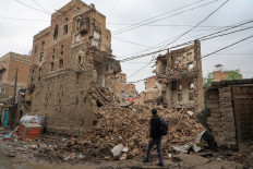 A Yemeni man walks by a collapsed UNESCO-listed building in the old city of the Yemeni capital Sanaa following heavy rains, on August 8, 2020.
