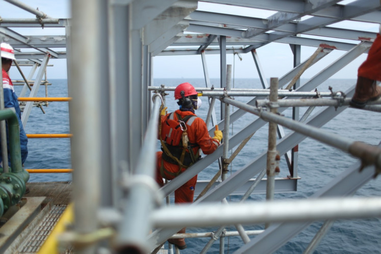 An Elnusa employee repairs an offshore oil and gas rig. The publicly listed company is majority owned by state oil and gas giant Pertamina.