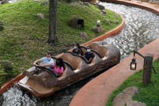 Social distancing seating measures are in place as people wearing facemasks ride Splash Mountain at Walt Disney World Resort's Magic Kingdom during the COVID-19 pandemic in Orlando on July 23, 2020. 