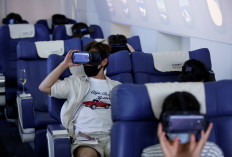 Customers in flight seats use virtual reality (VR) devices at First Airlines, that provides VR flight experiences, including 360-degree tours of cities and meals, amid the COVID-19 pandemic in Tokyo, Japan, on August 12, 2020. 
