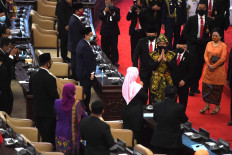 President Joko "Jokowi" Widodo (foreground, second right), Vice President Ma'ruf Amin (foreground, right), People's Consultative Assembly Speaker Bambang Soesatyo (foreground, center) and House of Representatives Speaker Puan Maharani (right) make their exit after attending the annual joint session of the House and the Assembly at the Senayan legislative complex in Central Jakarta, on Aug. 14, 2020.