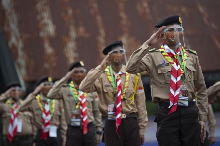National Scout (Pramuka) members salute during a National Scout Day ceremony in Cibubur, East Jakarta, on Aug. 14, 2020.