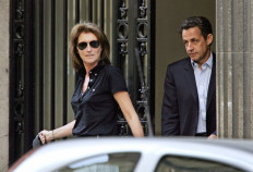 In this file photo taken on April 22, 2007 French right-wing UMP presidential candidate Nicolas Sarkozy (R) leaves his home with his wife Cecilia after casting his ballot at the Ile-de-la-Jatte in Neuilly-sur-Seine. 