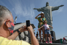 Tourists enjoy a visit to the Christ The Redeemer statue, at the Corcovado Hill, in Rio de Janeiro, Brazil, on August 15, 2020, during the reopening day of touristic attractions in the city amid the COVID-19 novel coronavirus pandemic.
