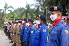 Government workers join a parade at the Papua provincial government office in August 2020.