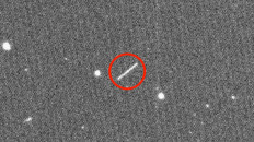 This NASA/JPL/ZTF/Caltech Optical Observatories handout image obtained on August 18, 2020 shows asteroid 2020 QG (the circled streak in the center) which came closer to Earth than any other nonimpacting asteroid on record. 