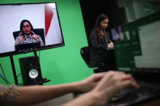 Sri Mulyani Indrawati, Finance Minister accompanied with moderator Ester Samboh, Deputy Managing Editor The Jakarta Post and Yunindita Prasidya, The Jakarta Post journalist, gives her speech as the main speaker in Webinar Jakpost Up Close theme Reimagining the future of Indonesia’s economy in Jakarta, on Wednesday August 19. 2020. 