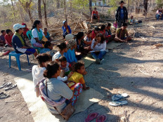 Members of the Besipae community sit after an eviction on Aug. 18 in South Central Timor, East Nusa Tenggara.