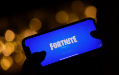This file illustration photo taken on August 14, 2020 shows a person logging into Epic Games' Fortnite on their smartphone in Los Angeles. 