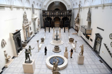 Museum employees wearing a face mask or covering due to the COVID-19 pandemic, pose in the Paul and Jill Ruddock gallery, during a photocall at the Victoria and Albert (V&A) museum in London on August 4, 2020.