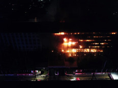 Flames engulf the Attorney General's Office building in South Jakarta on Aug. 22.