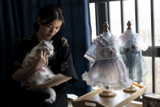 This photo taken on August 13, 2020, shows Wu Qiuqiao holding her cat Liu Liu at her house in Changsha China's central Hunan province.