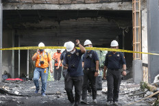 Police name eight suspects in AGO building blaze
