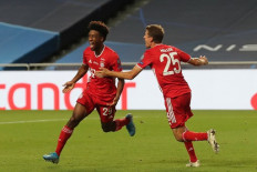 Bayern Munich's French forward Kingsley Coman celebrates scoring the opening goal with his teammate Bayern Munich's German forward Thomas Mueller during the UEFA Champions League final football match between Paris Saint-Germain and Bayern Munich at the Luz stadium in Lisbon on Sunday. 