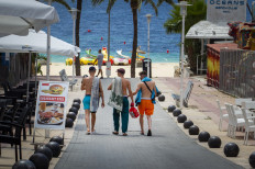 Tourists walk at General Garcia Ruiz street in Magaluf, Calvia, in Spain's Balearic island of Majorca on July 16, 2020. 