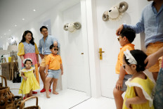 Yoon Seok-min and Kim Hyo-jung pose for photographs with their children at their home in Yongin, South Korea, August 13, 2020. 