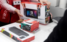 A customer purchases Nintendo Switch game console at a shop in Tokyo on March 3, 2017. 