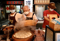 This photo taken on August 18, 2020 shows 80-year-old Wu Huang-yi, owner of Yuan Fang Gua Bao restaurant, preparing food with his family at the Huaxi Night Market in the Wanhua district in Taipei. 