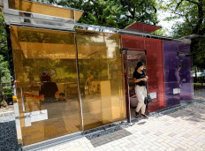 Visitors try out the transparent public toilets that become opaque when occupied, designed by Japanese architect Shigeru Ban, at Yoyogi Fukamachi Mini Park in Tokyo, Japan August 26, 2020. 